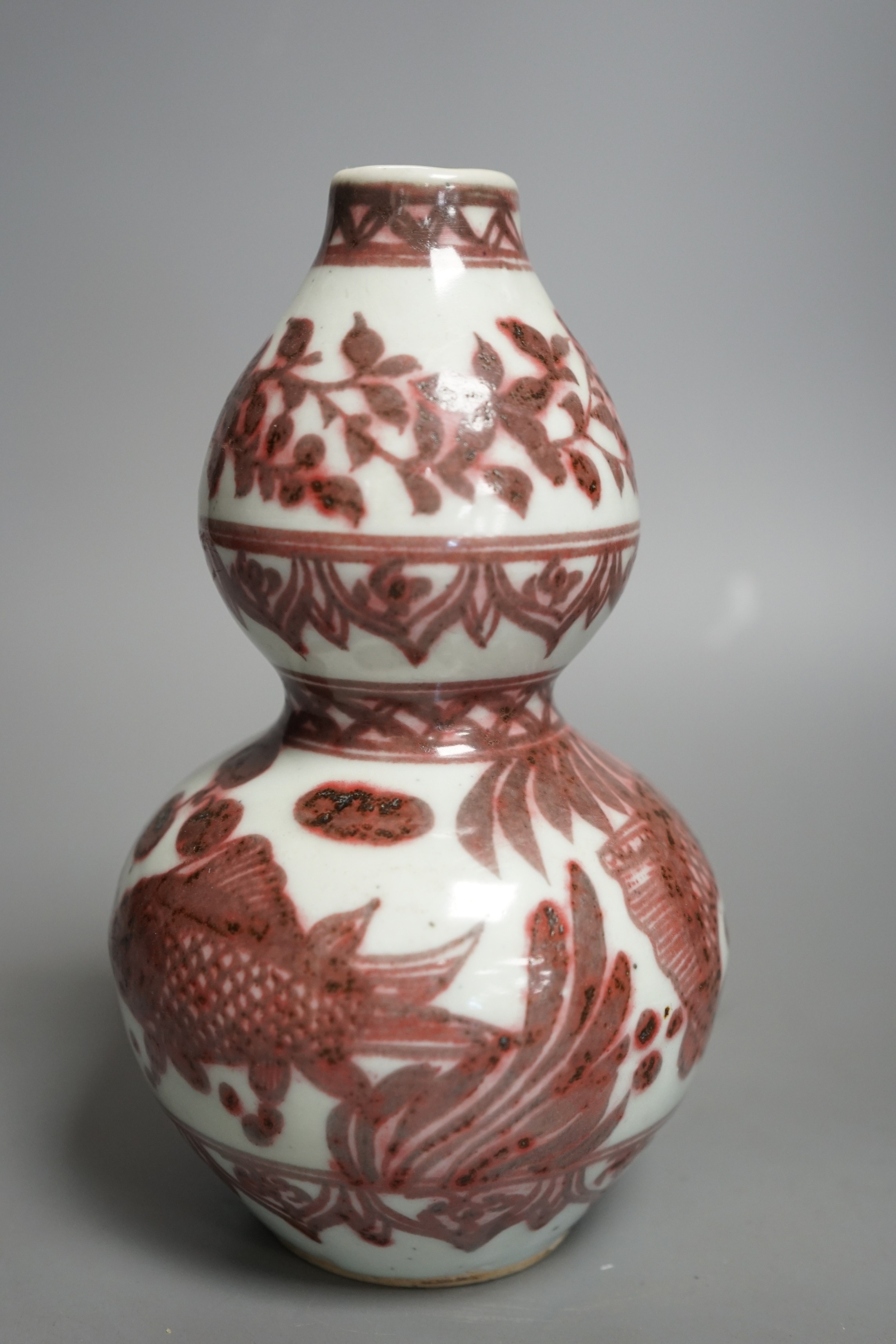 A Chinese underglaze copper red double gourd vase, 20cms high